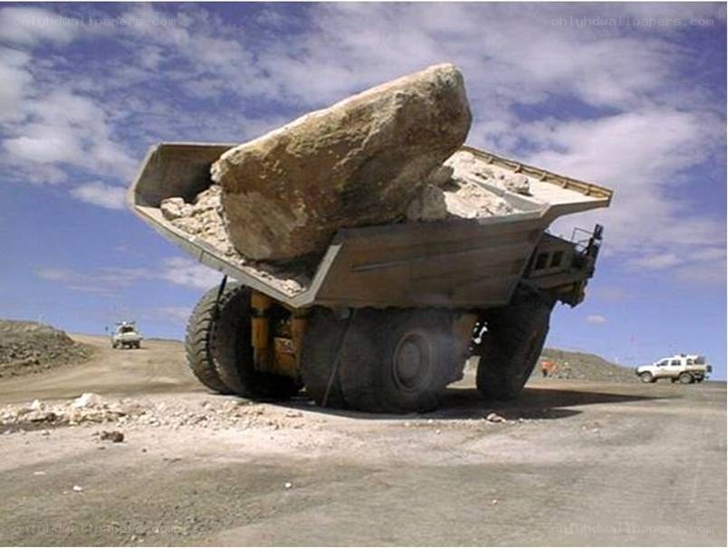 Large truck carrying a boulder