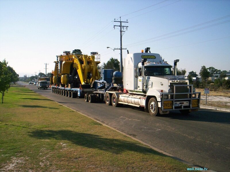 Large truck carrying heavy machinery