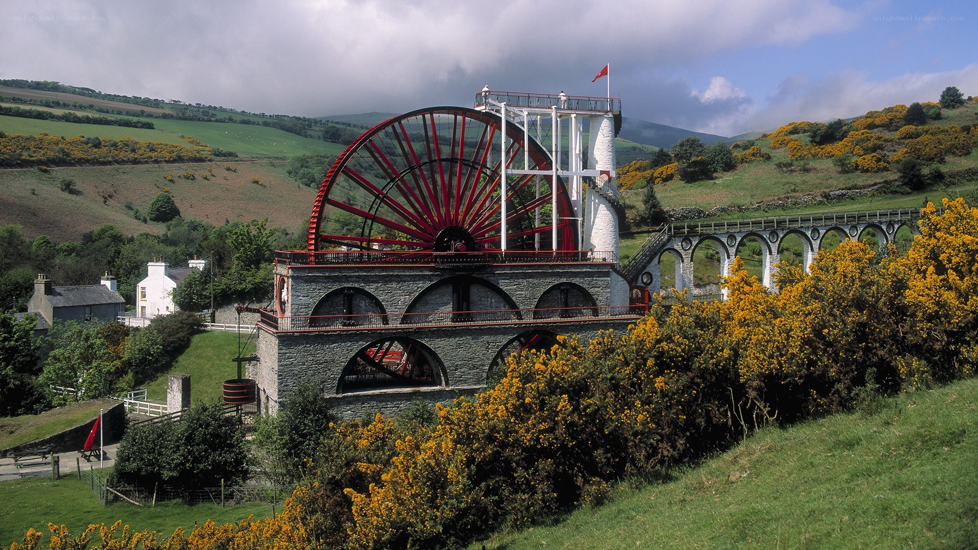 Large waterwheel in a rural landscape