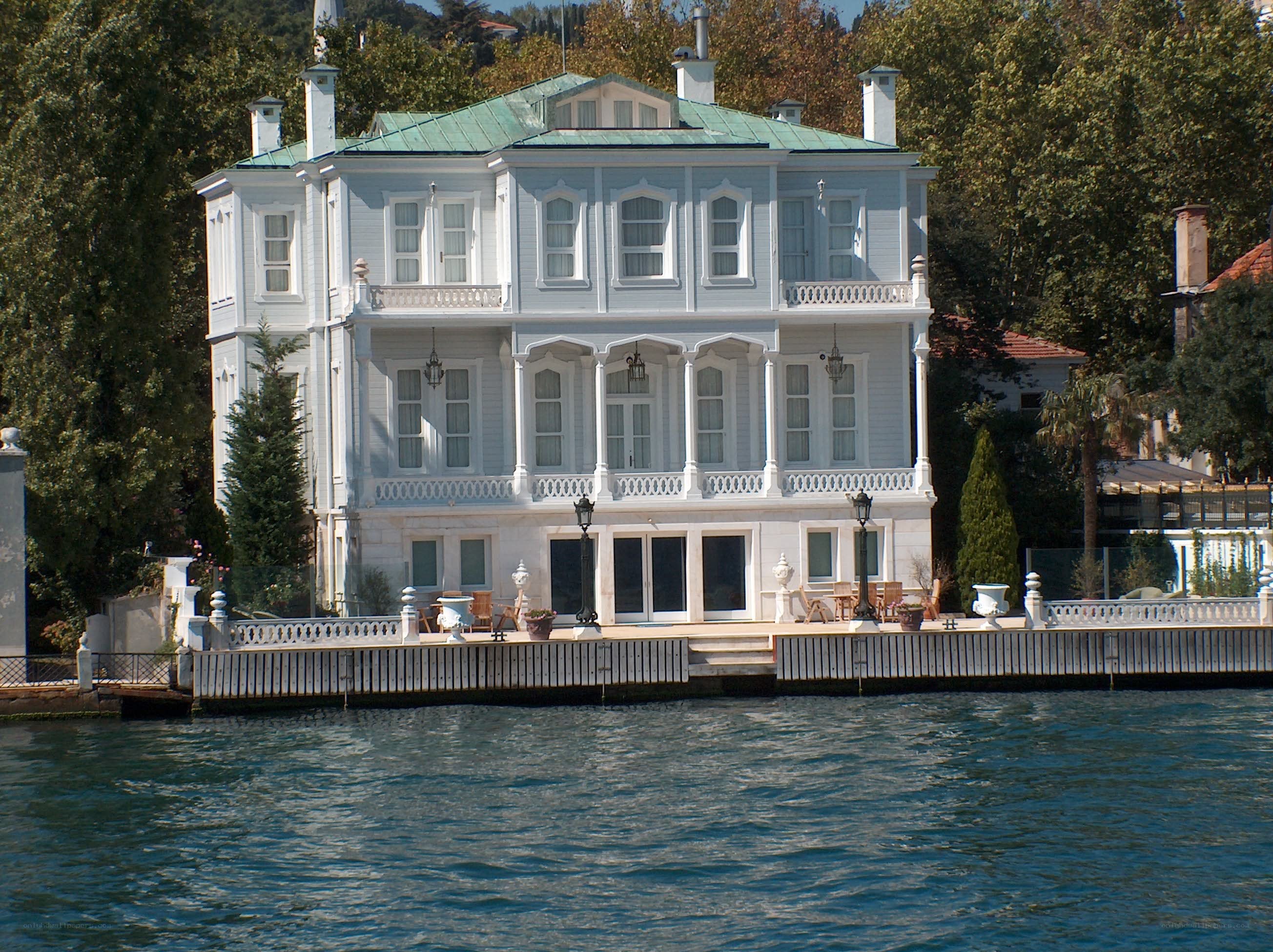 Large white house by the water