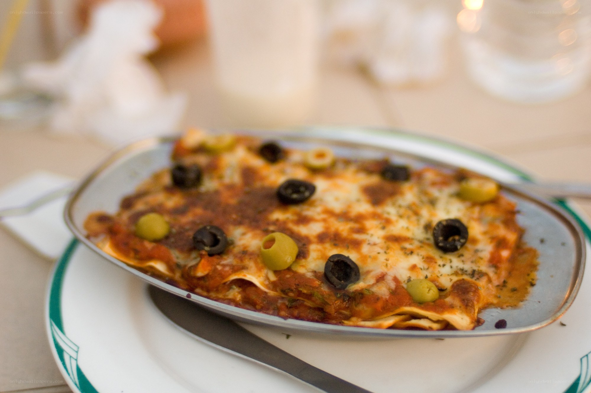 Lasagna with olives on a plate