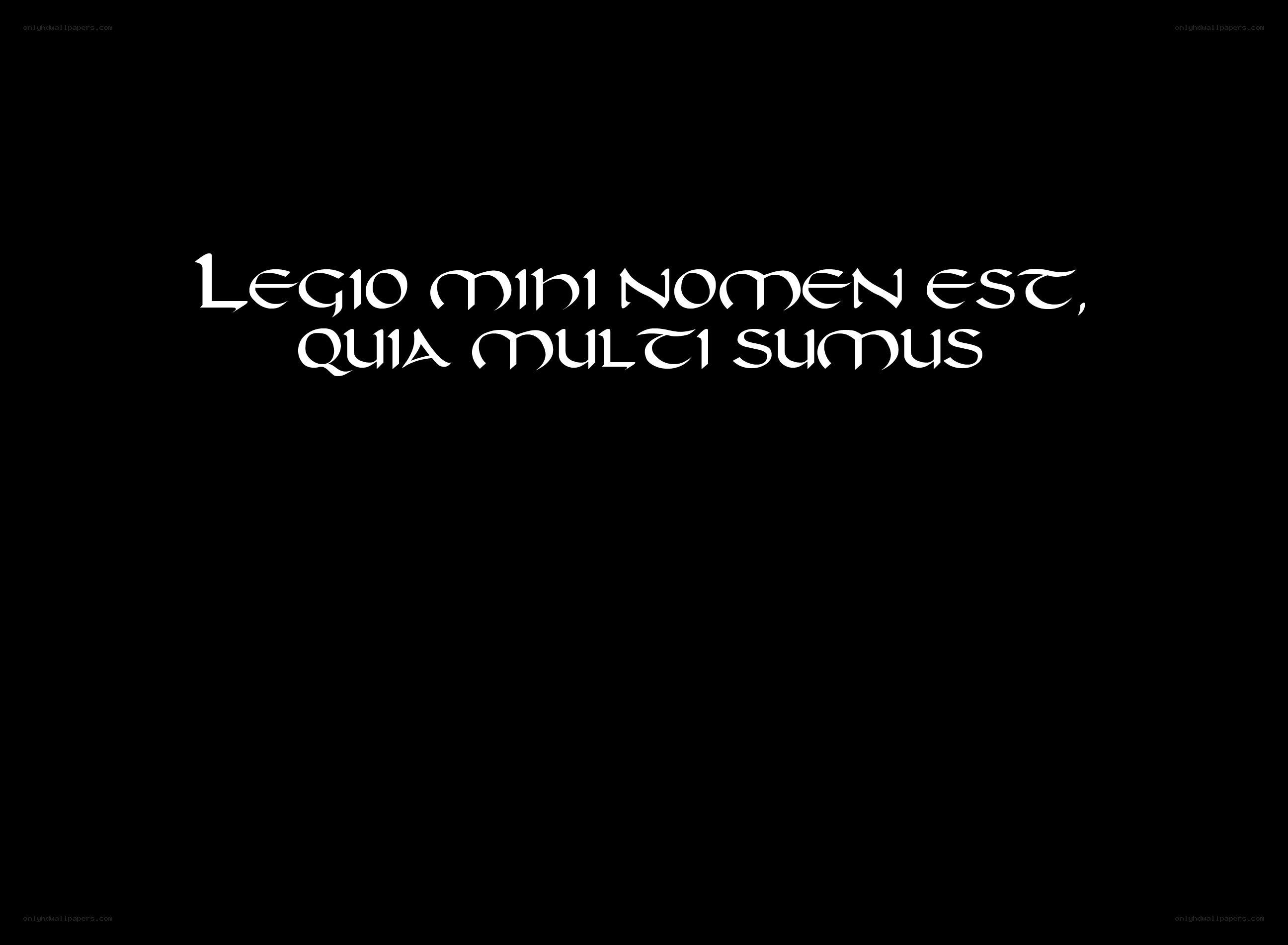 Latin phrase on black background