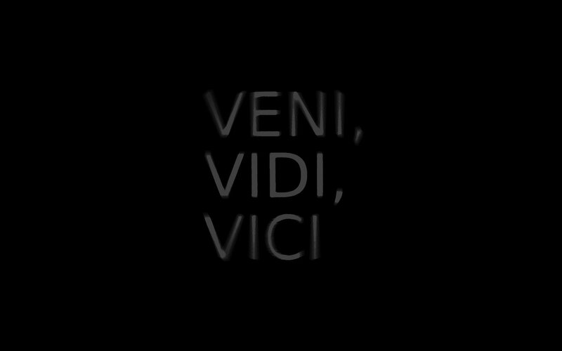 Latin phrase on black background