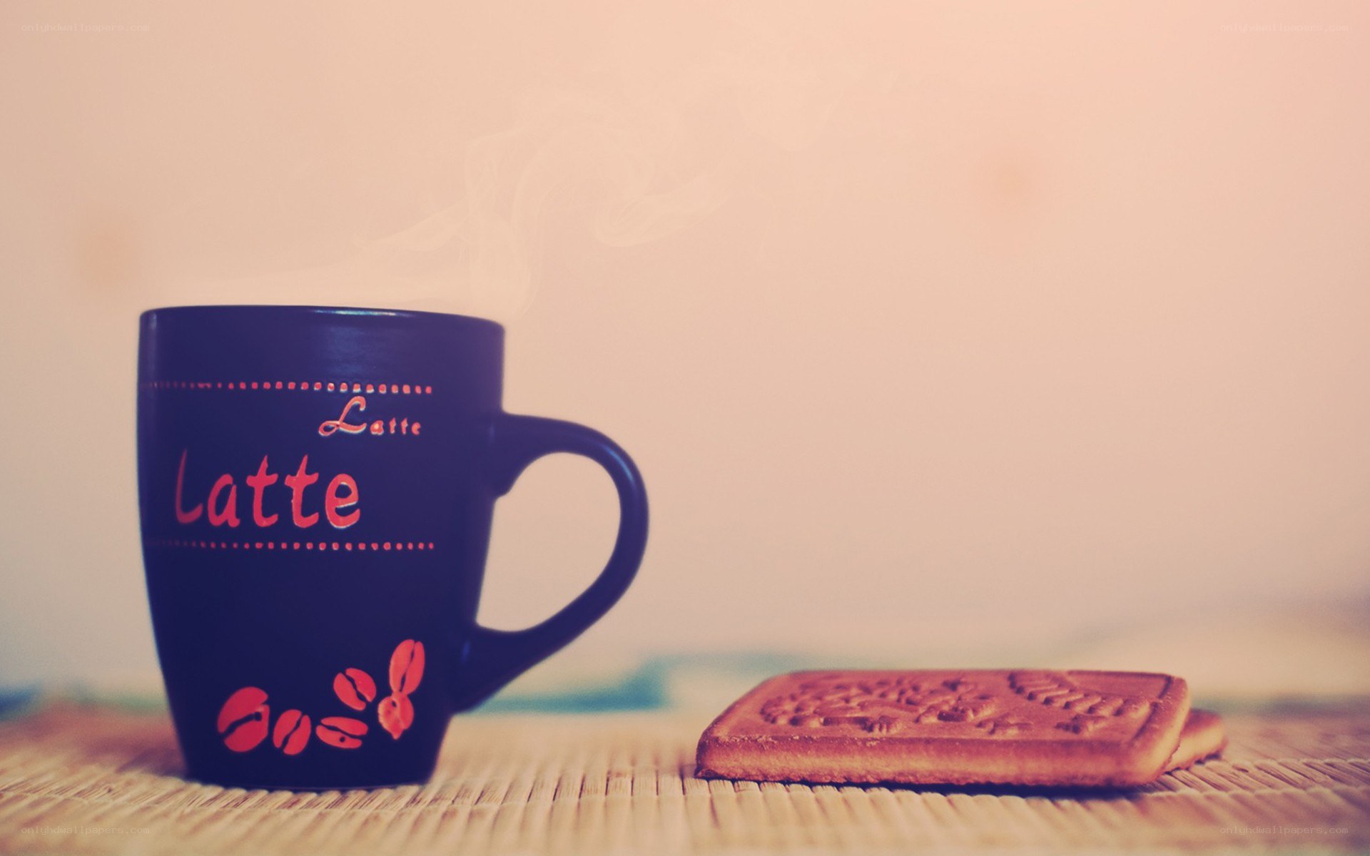 Latte and biscuit on mat