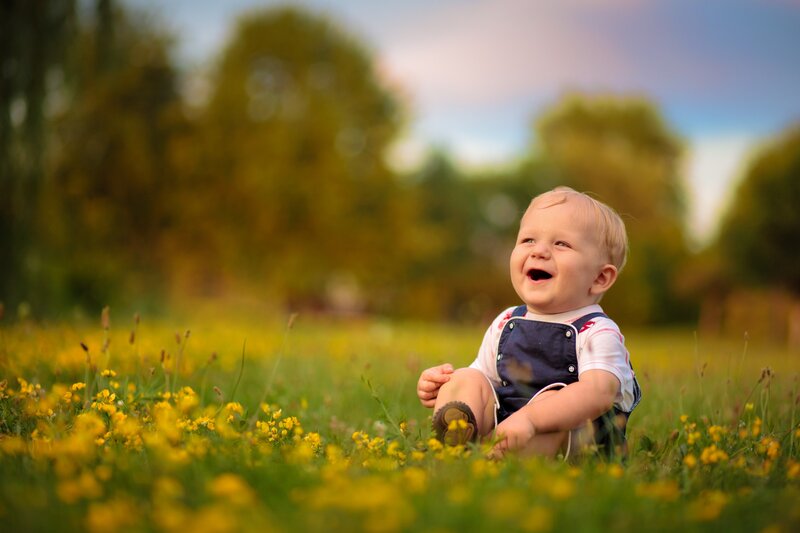 Laughing baby in a field