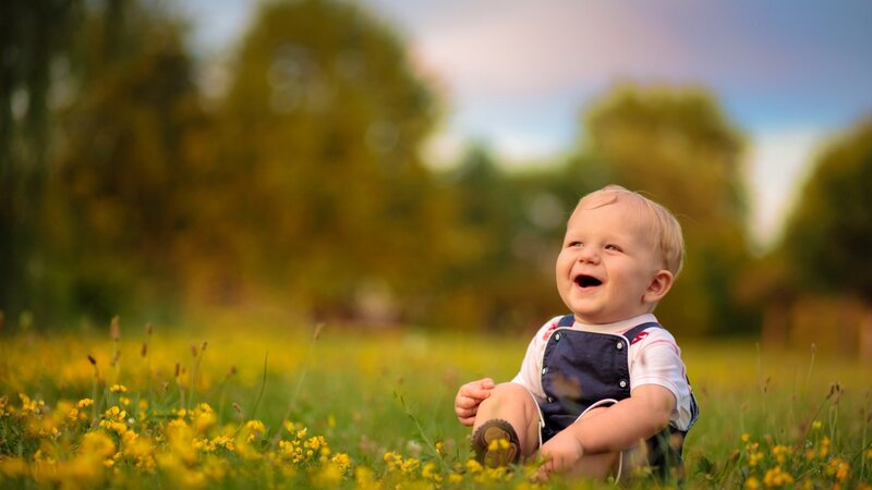 Laughing baby in a field