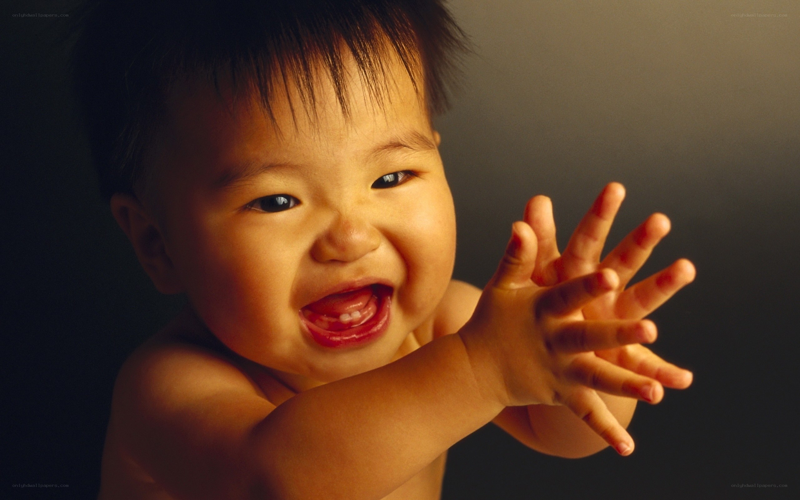 Laughing baby reaching out