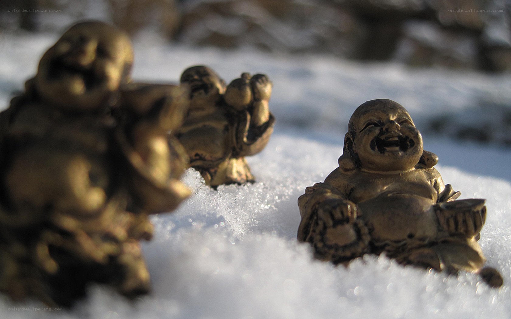 Laughing Buddha statues in snow