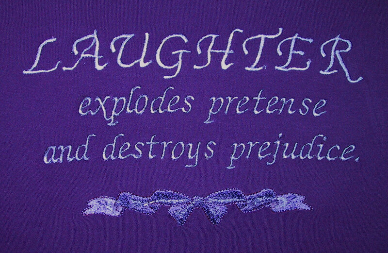 Laughter quote on purple fabric