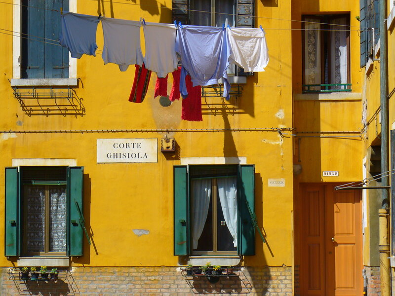 Laundry drying on a yellow building