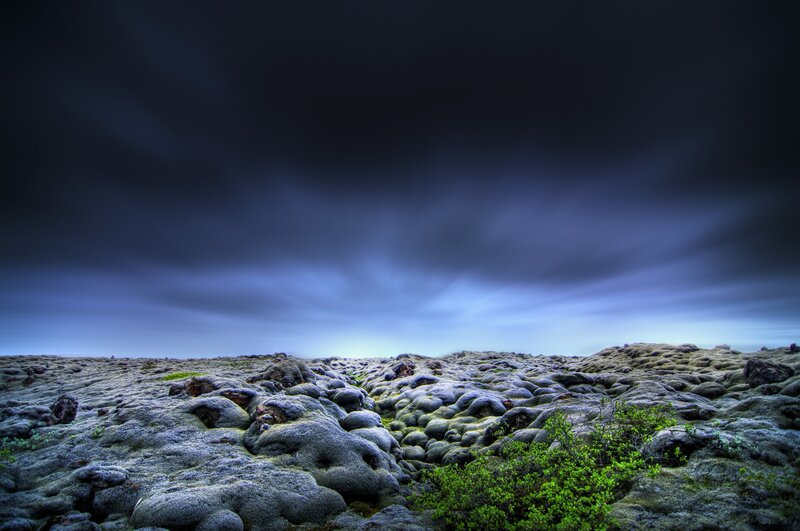 Lava field under stormy sky