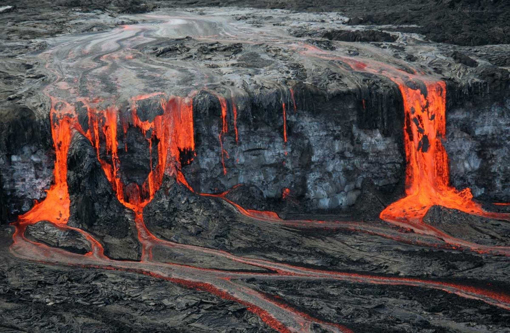 Lava flows from volcanic cliff