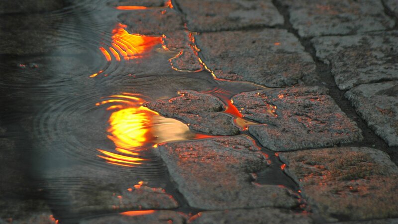 Lava reflections on cobblestones