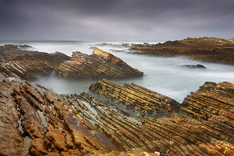 Layered coastal rocks at sea