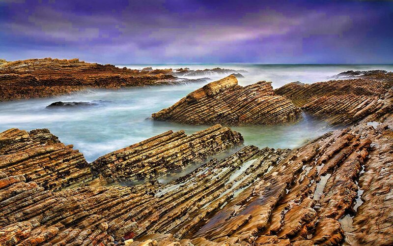 Layered coastal rocks at sea