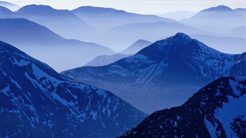 Layered mountain peaks in blue haze