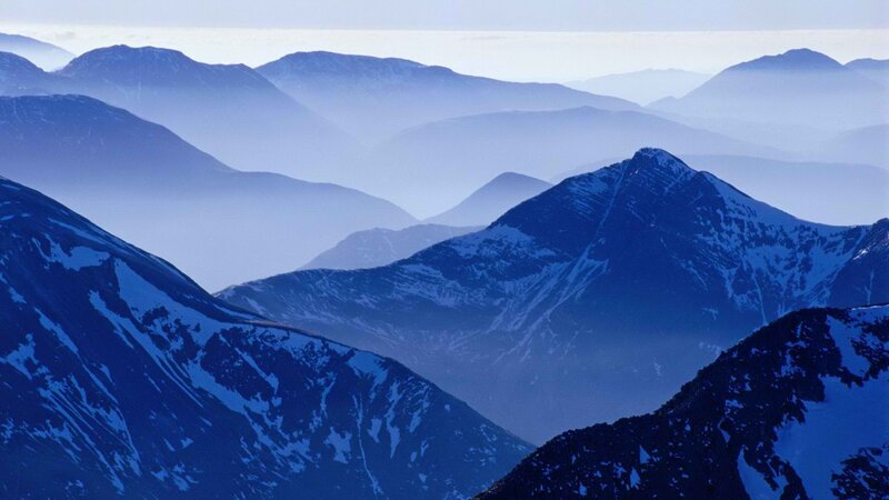 Layered mountain peaks in blue haze