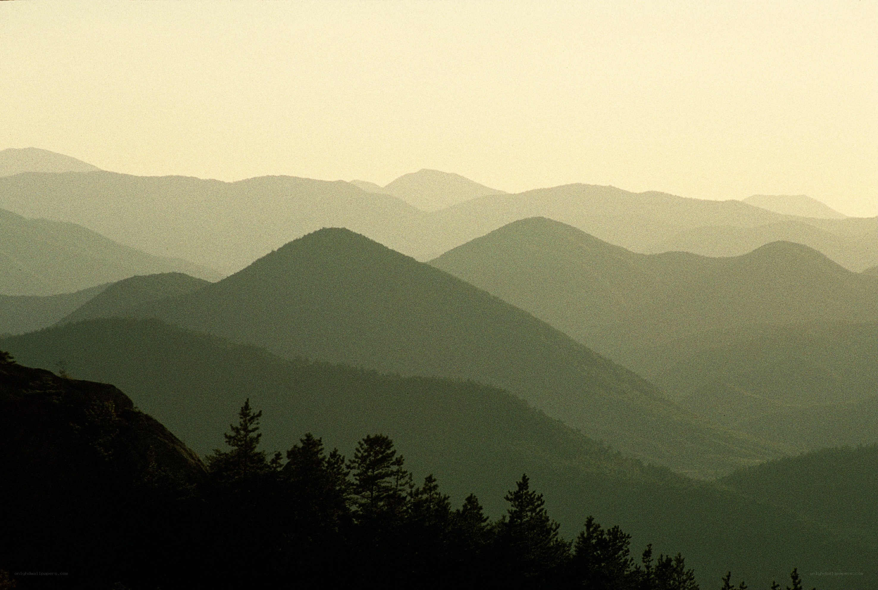 Layered mountain ranges at dawn