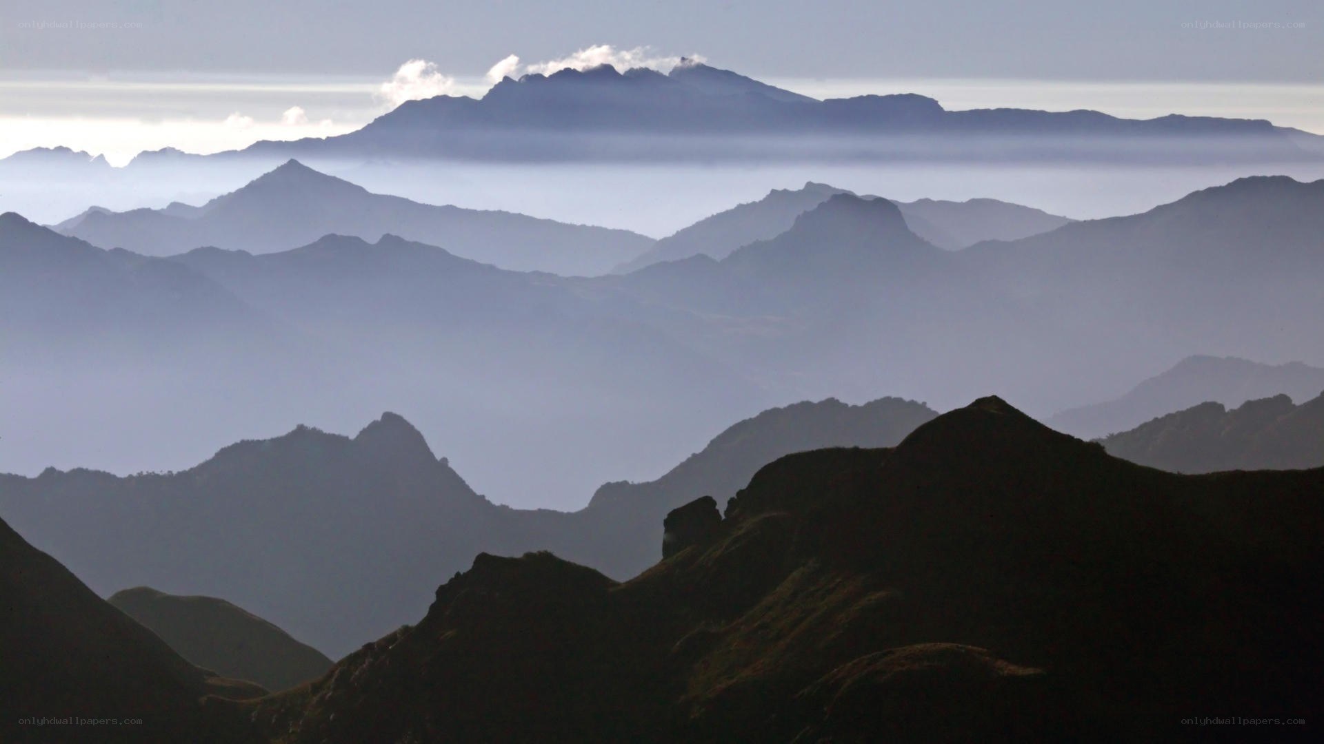 Layered mountain ranges at dawn