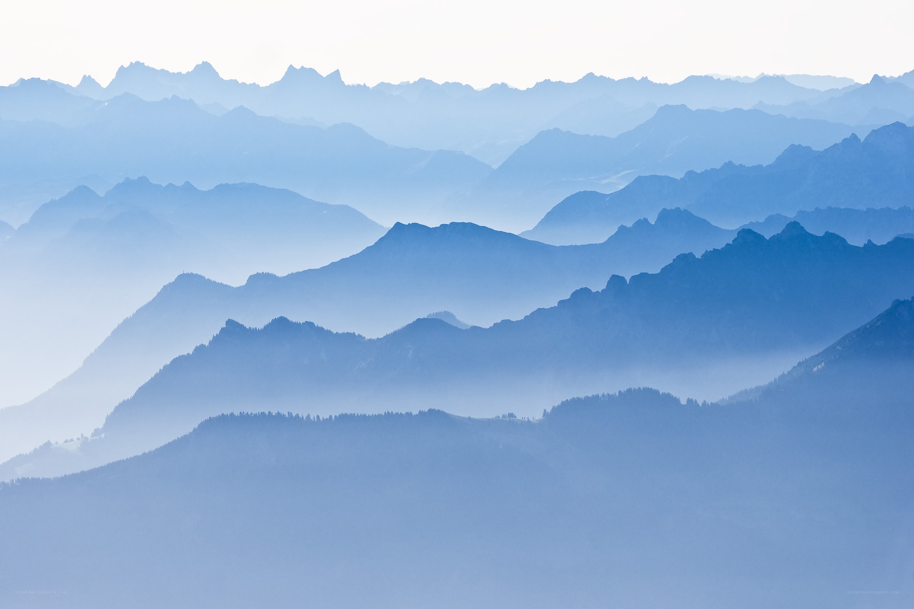 Layered mountain ranges in mist