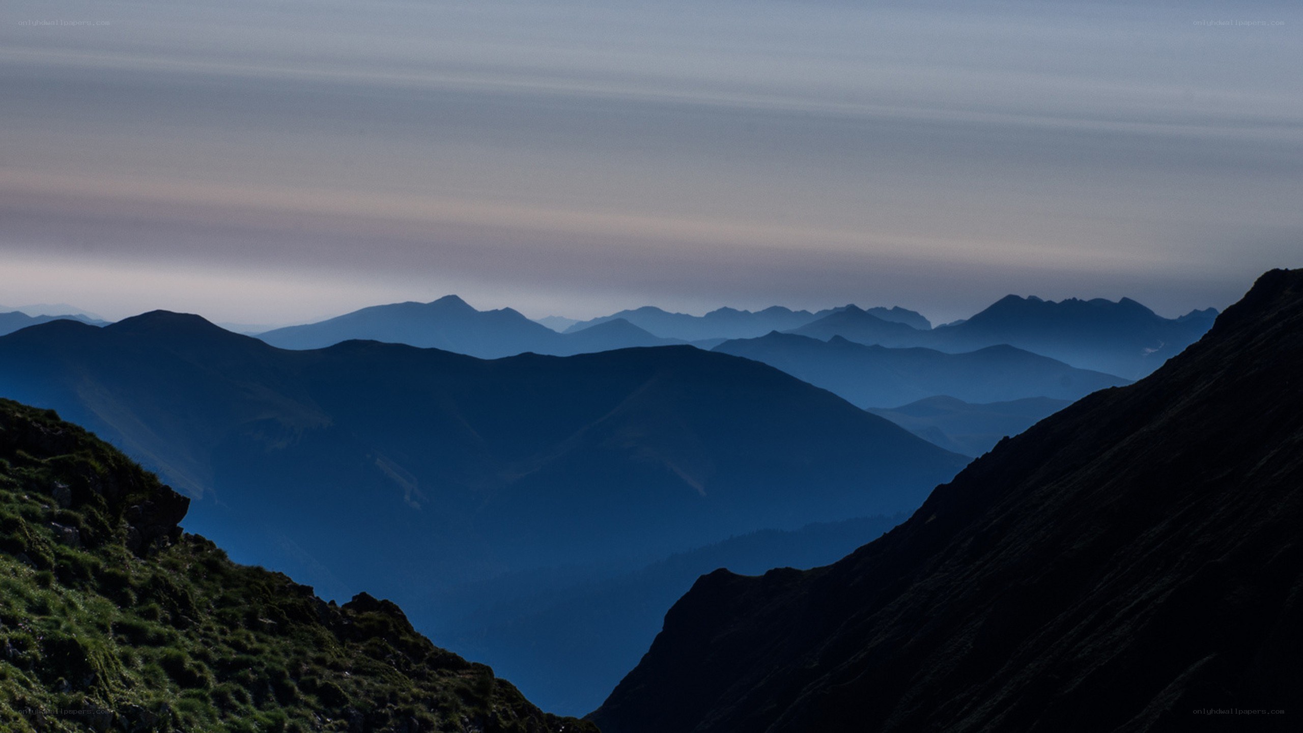 Layered mountain silhouettes at dusk