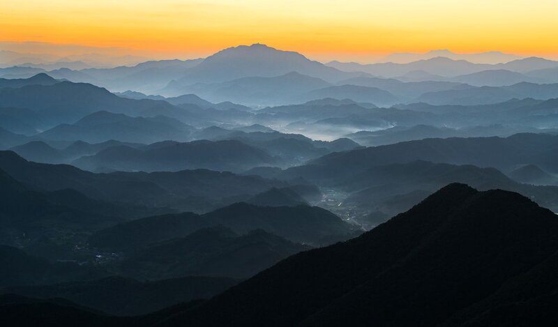 Layered Mountains at Dawn — Orange