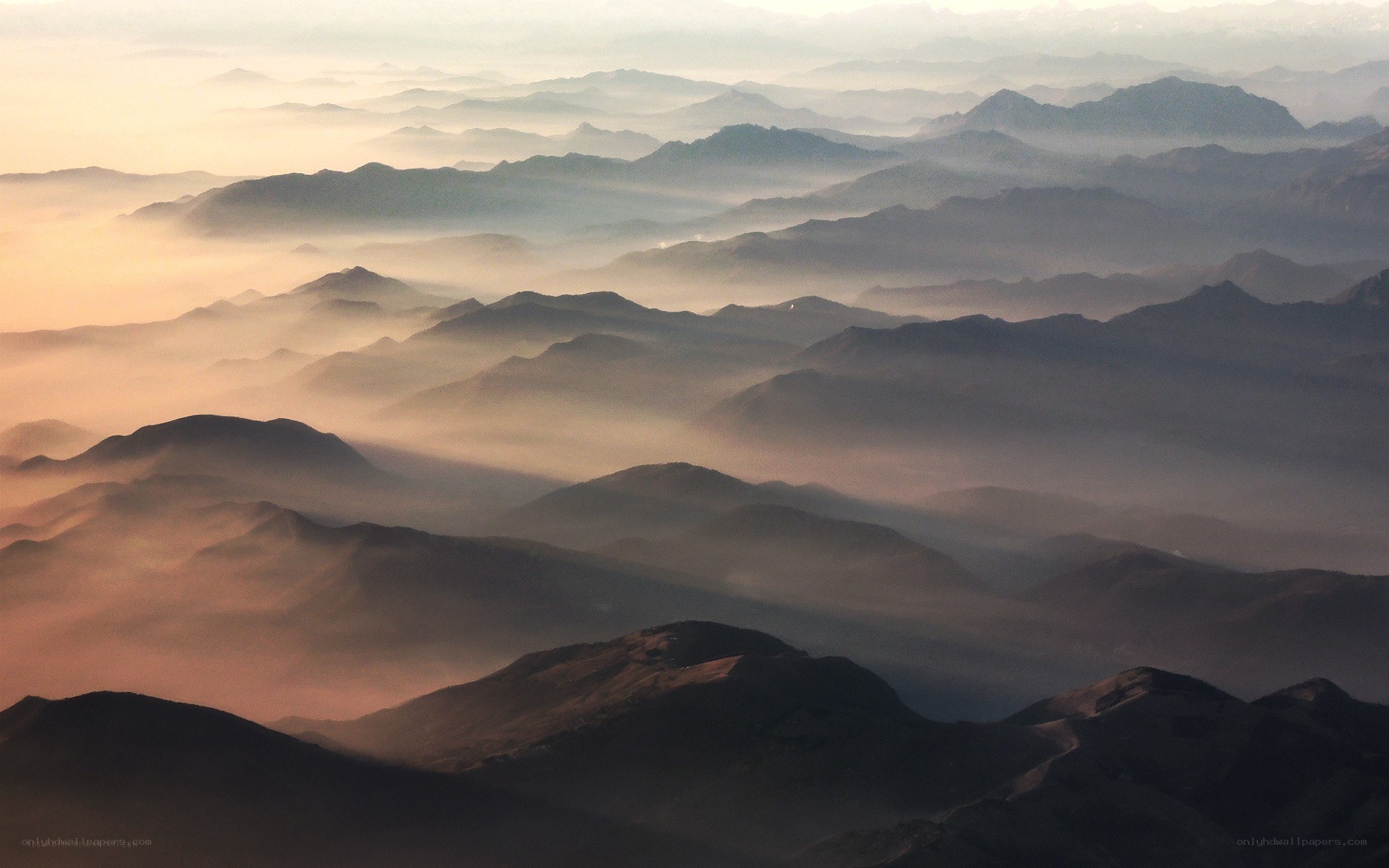 Layered mountains at sunrise