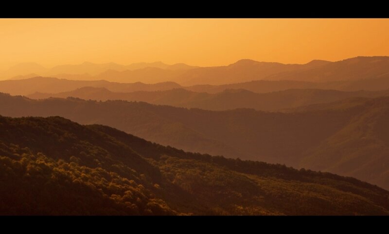 Layered Mountains at Sunset — Orange
