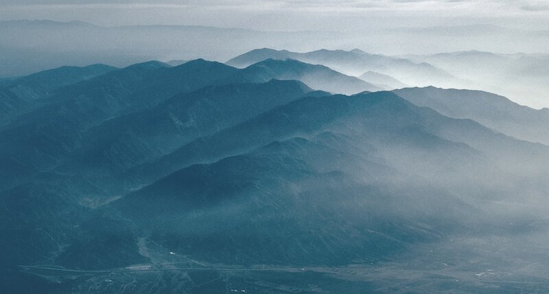 Layered Mountains in Fog — Blue