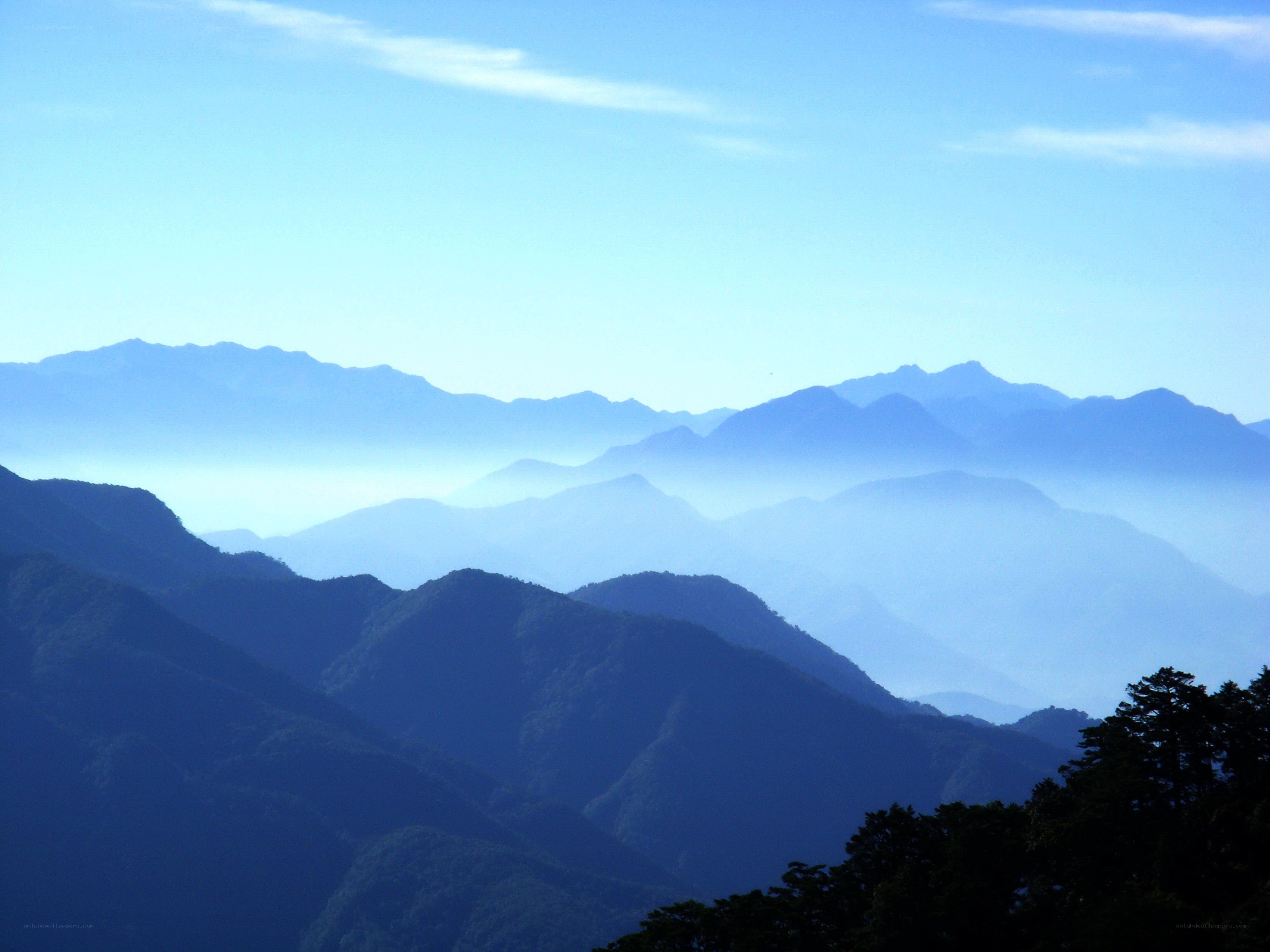 Layered mountains under blue sky