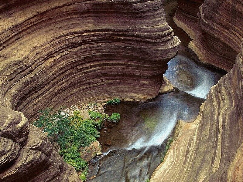 Layered rock canyon with stream