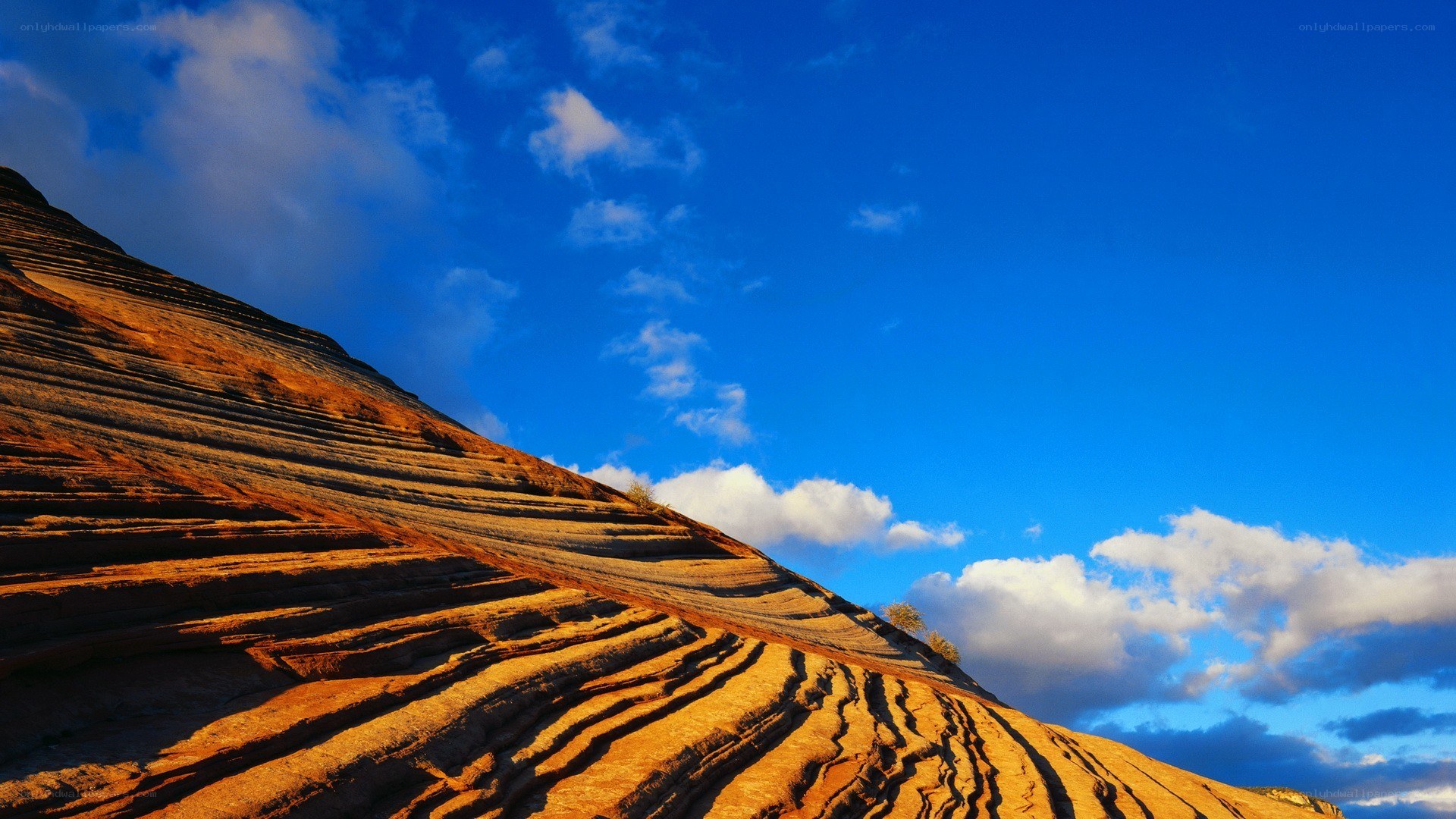 Layered rock formations under blue sky