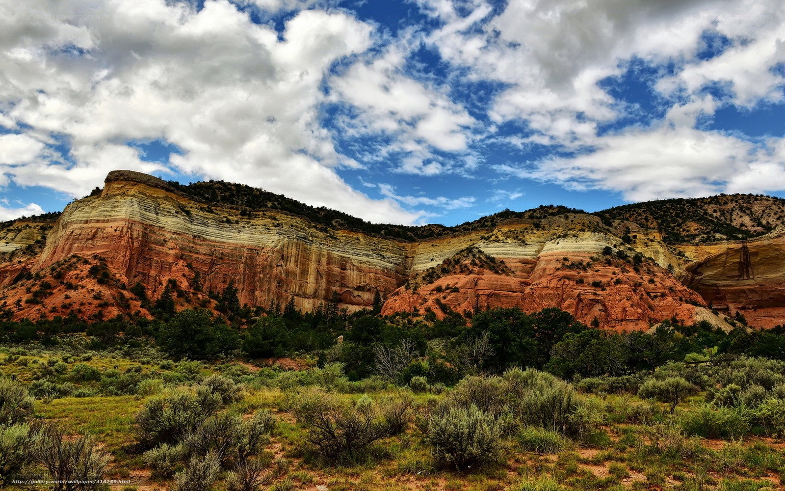 Layered rock formations under cloudy sky