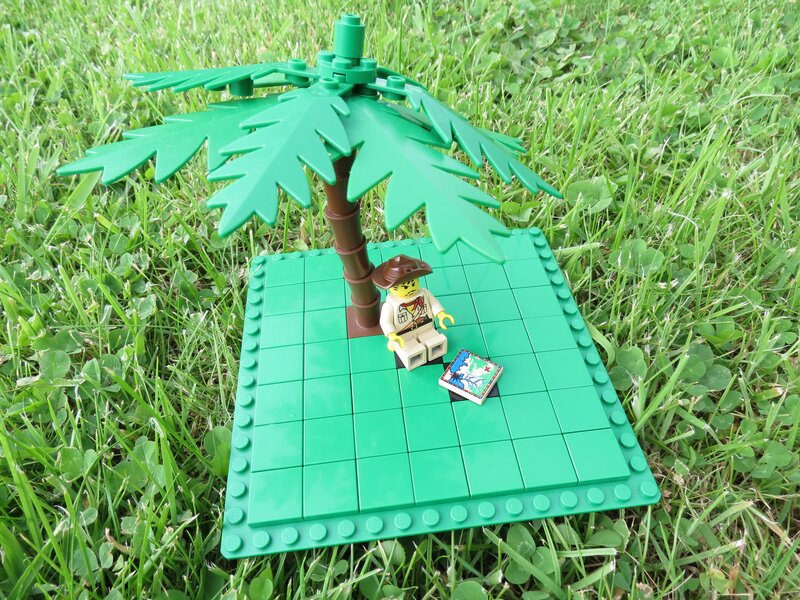 Lego explorer under palm tree
