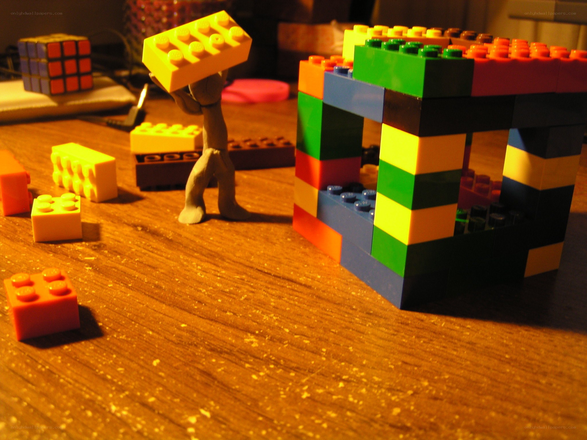 Lego figure carrying a block