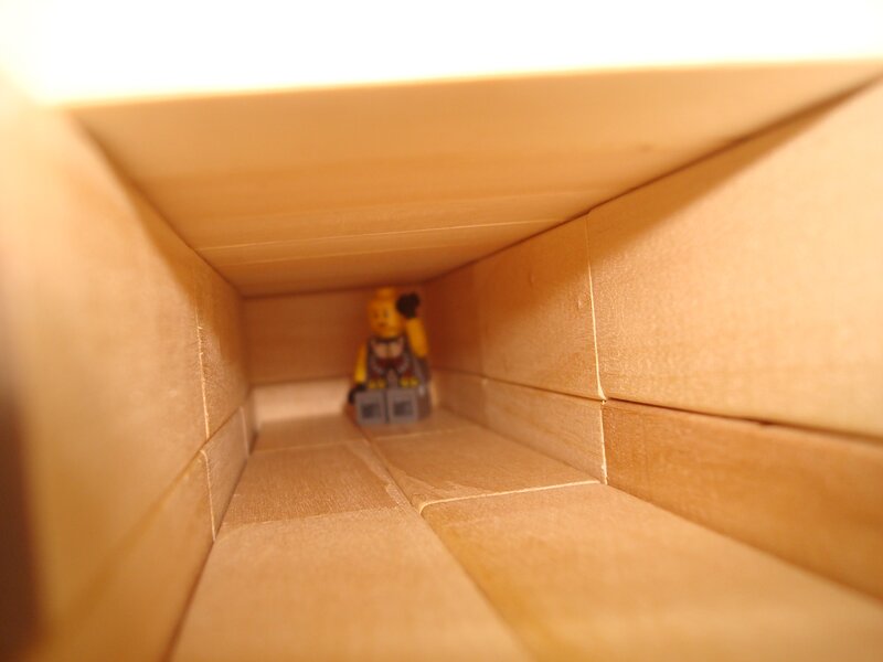 Lego figure in cardboard tunnel