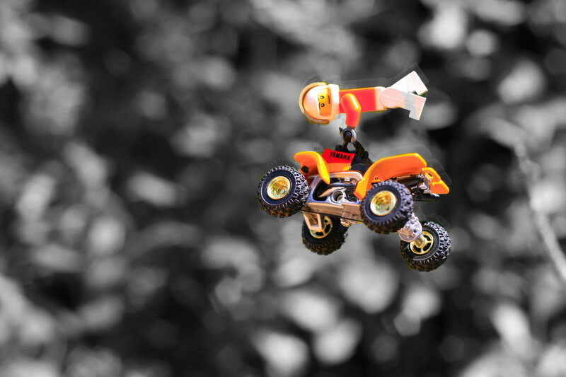 Lego figure on ATV mid-air