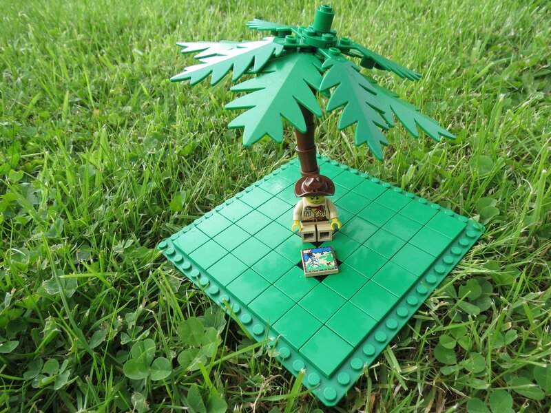 Lego figure under palm tree