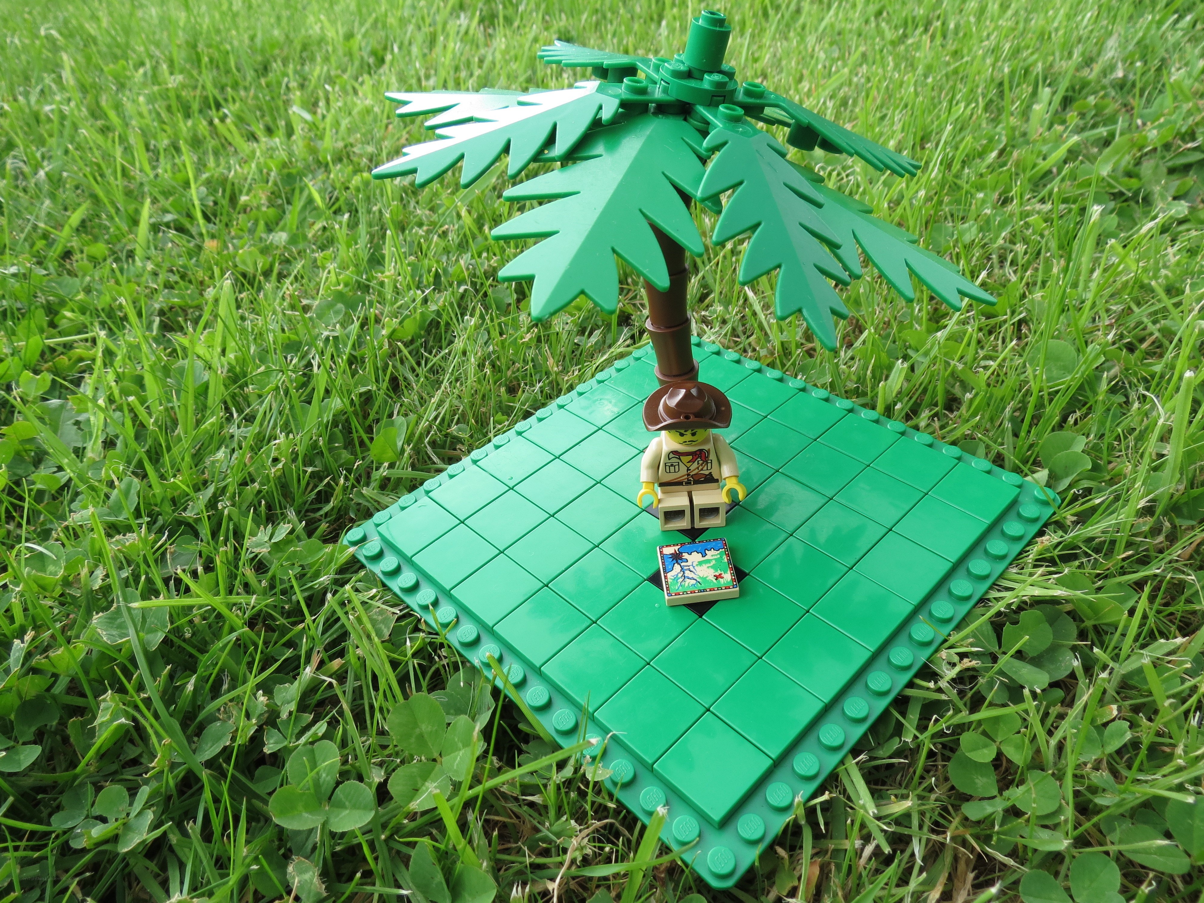 Lego figure under palm tree