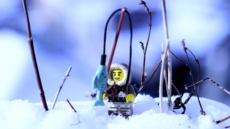 Lego minifigure fishing in snow