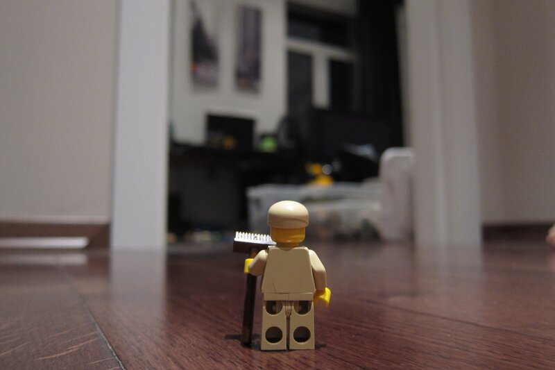 Lego minifigure on wooden floor