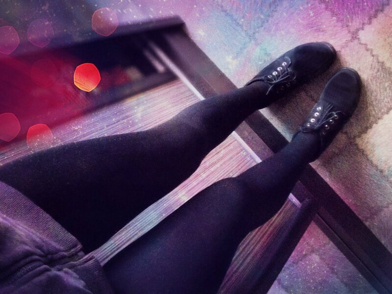 Legs in black tights and shoes