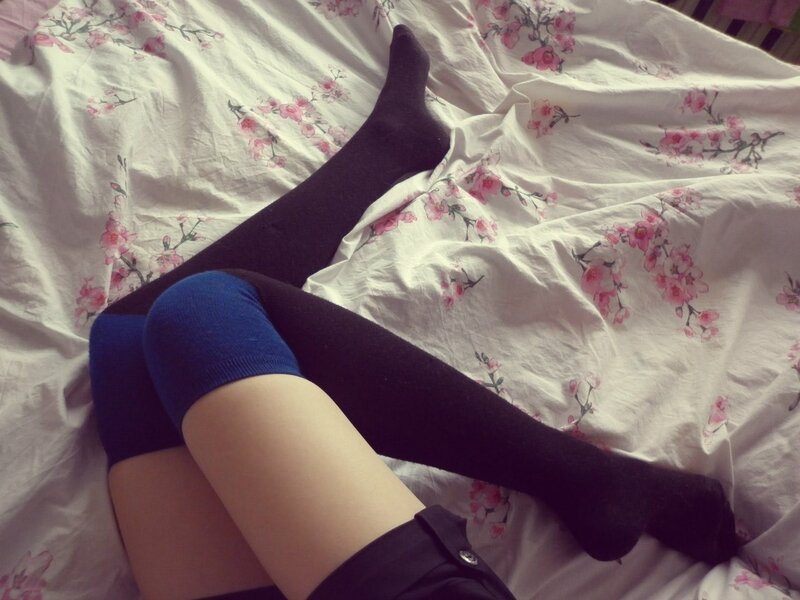 Legs in socks on floral bed
