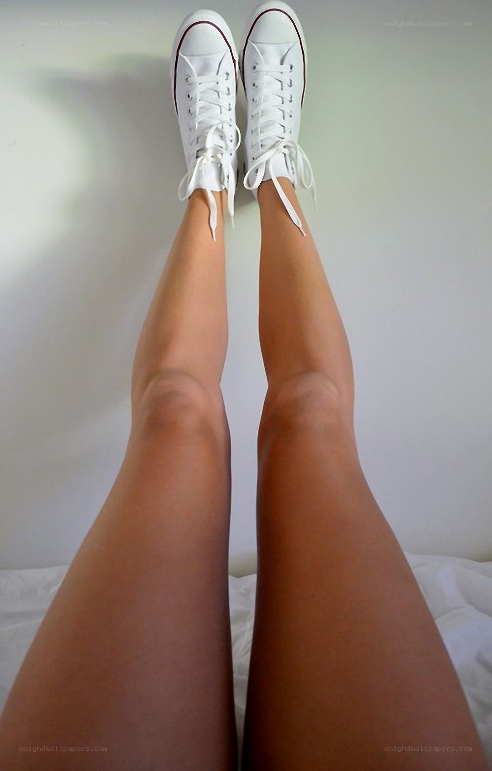legs in white sneakers
