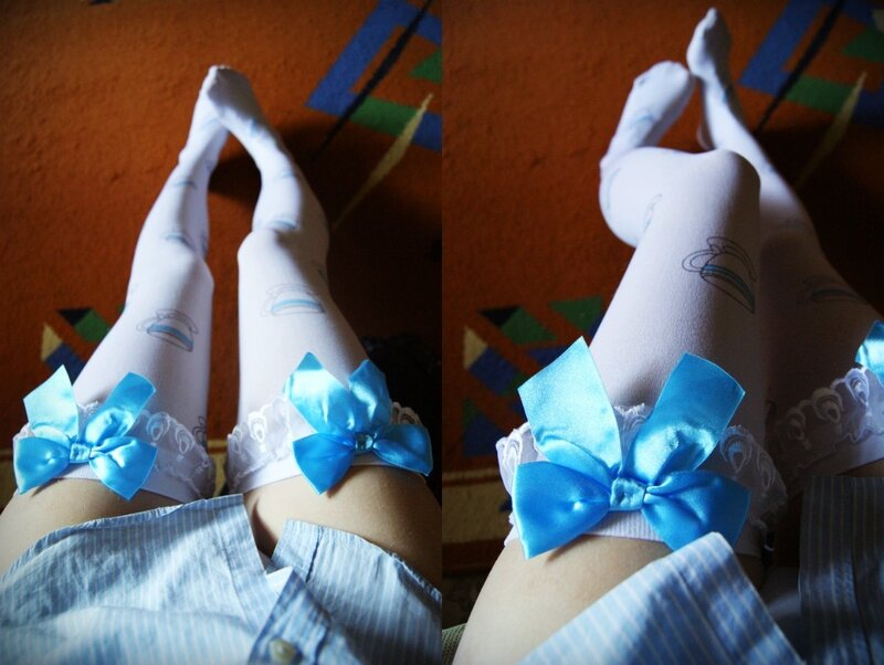 legs in white tights with blue bows