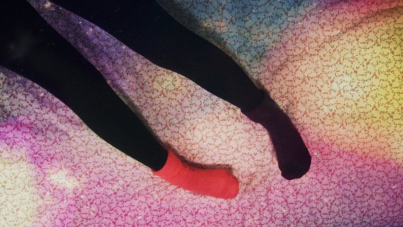 legs on colorful patterned surface