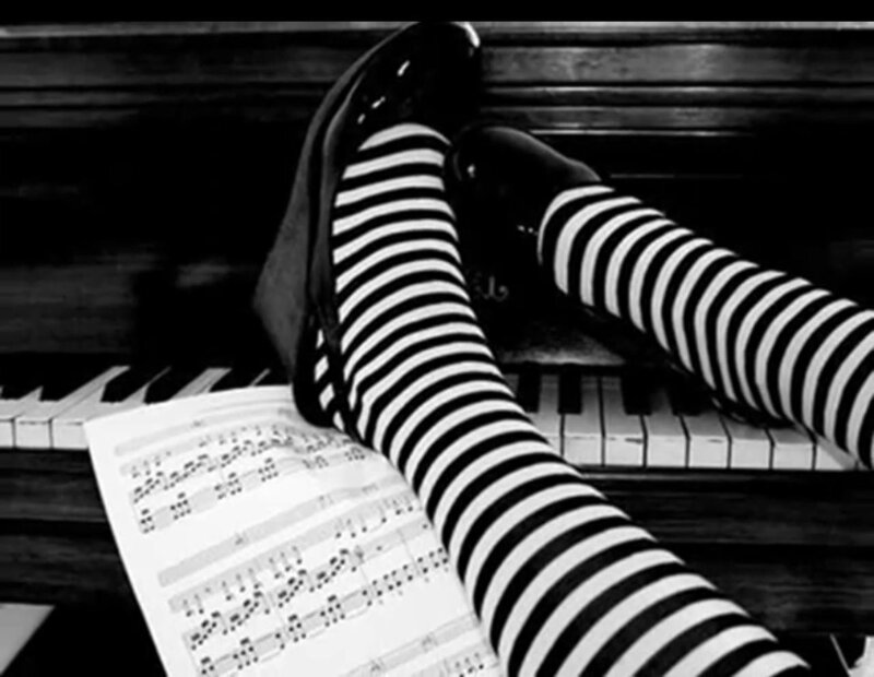 legs on piano with sheet music