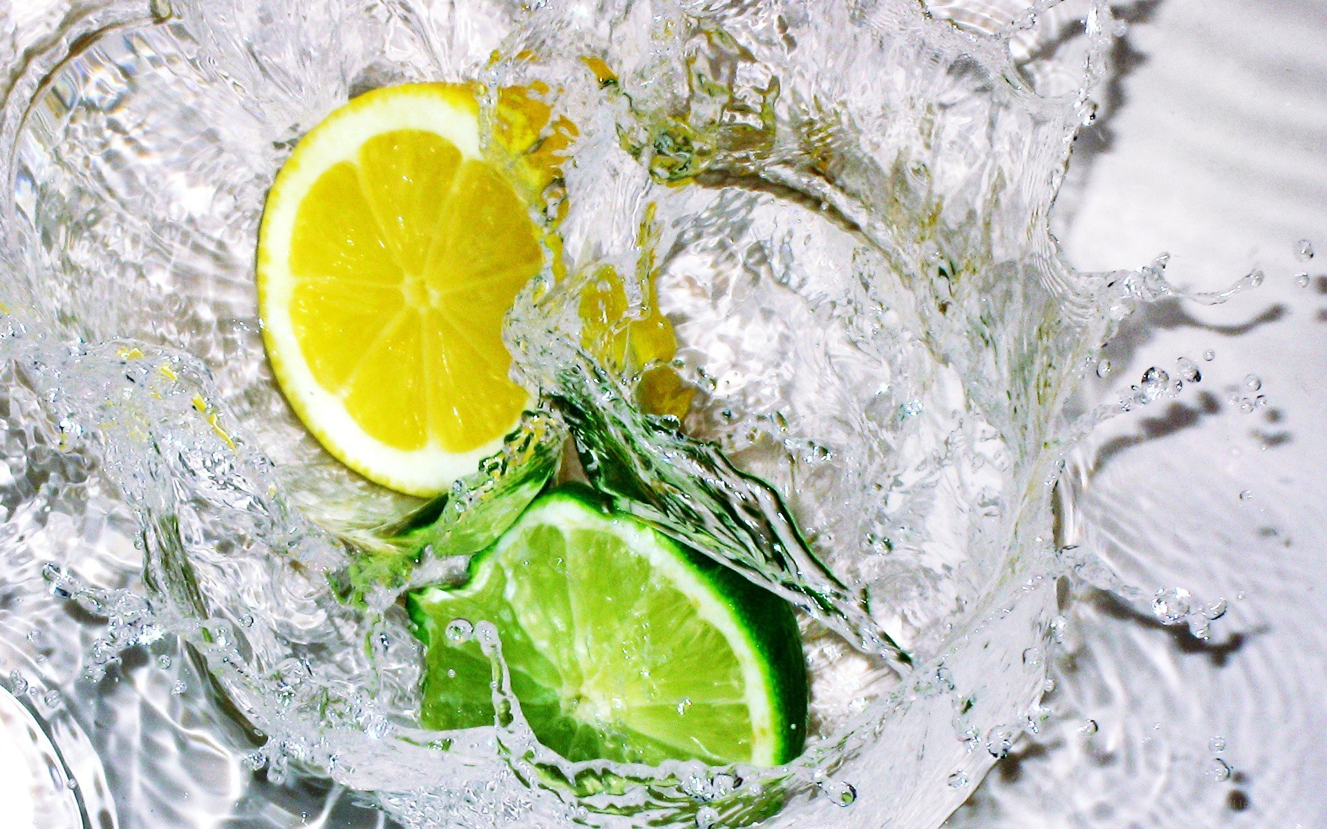 lemon and lime in water splash