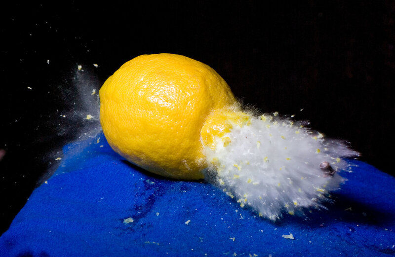 lemon exploding on blue surface