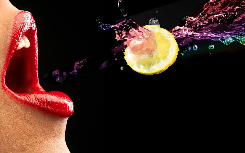 Lemon splash into open mouth